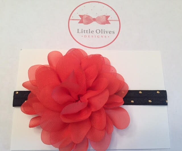 large coral chiffon flower with black band with gold dots