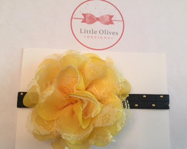 large yellow chiffon/lace flower with black band and gold dots