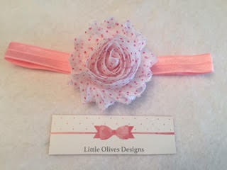 white flower with pink dots and light pink elastic headband