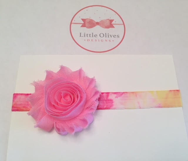 light pink flower with pink and yellow tie dye band
