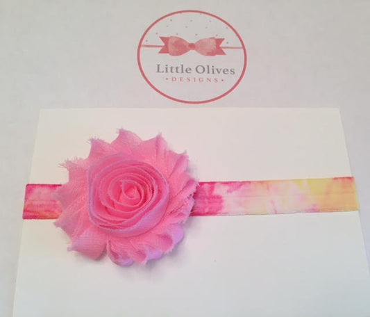 light pink flower with pink and yellow tie dye band