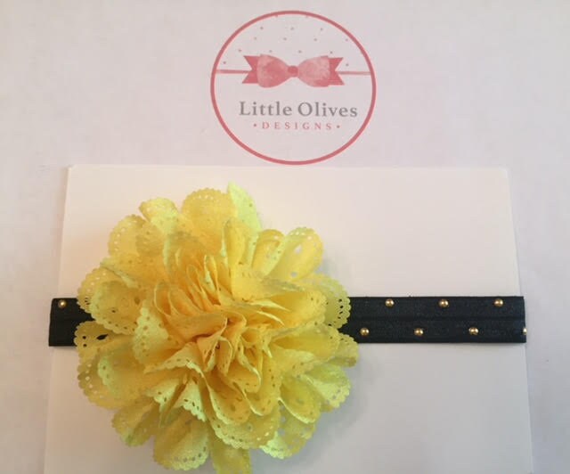 yellow eyelet flower with black band and gold dots